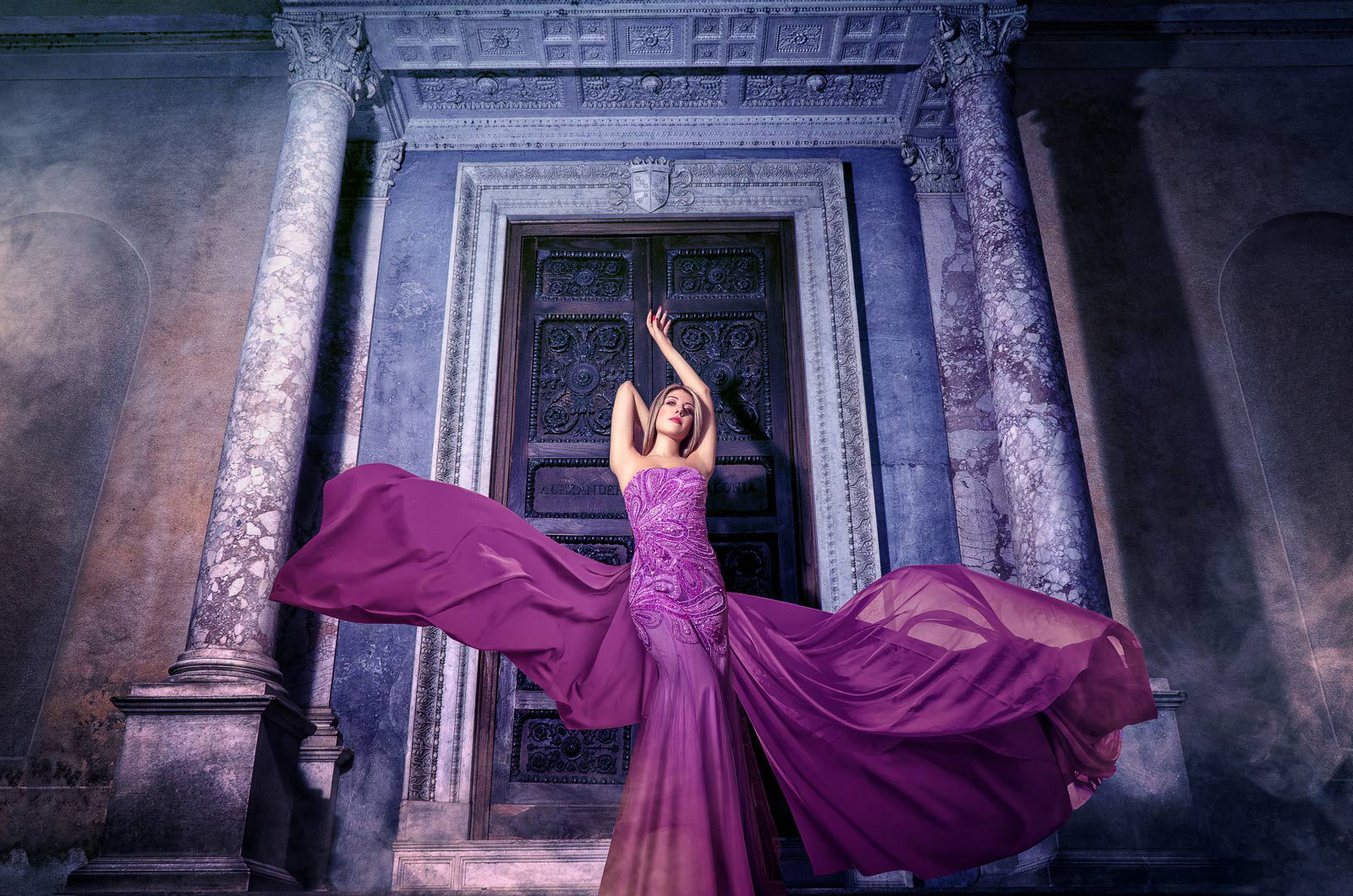 Fine art photography of a model wearing a purple flying dress