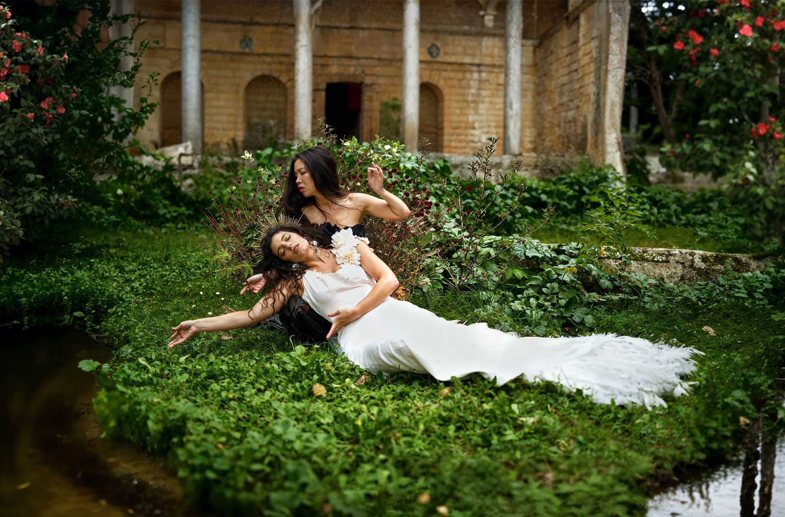 Two models are posing surrounded by nature