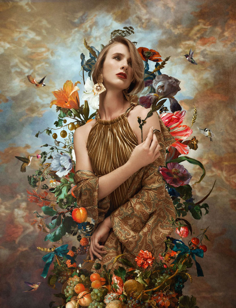 Painterly photography of a caucasian model wearing a gold dress surrounded by flowers and hummingbirds 