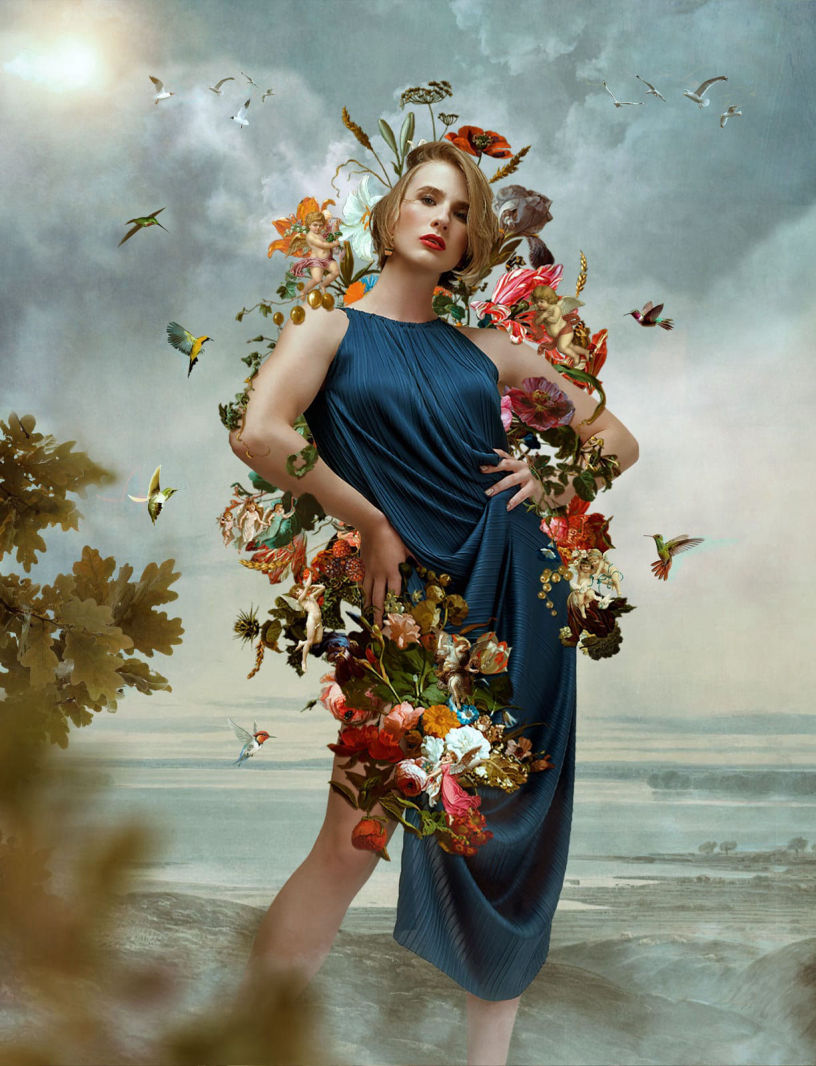 Painterly photography of a caucasian model wearing a blue tunic surrounded by flowers and hummingbirds 